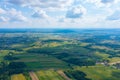 Aerial view on green and yellow parts of fields and countryside