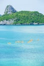 Aerial view, a group of tourists kayaking in the blue ocean at summer day, tropical islands backdrop. Mu Koh Ang Thong, Surat