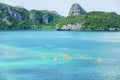 Aerial view, a group of tourists kayaking in the blue ocean at summer day, tropical islands backdrop. Mu Koh Ang Thong, Surat