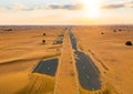 Aerial view of half desert road or street with sand dune in Dubai City, United Arab Emirates or UAE. Natural landscape background