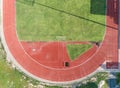 Aerial view on Half of soccer field, football field with Numbers on red running track. Royalty Free Stock Photo