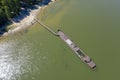 Aerial view of a half-sunken rusty barge at the last berth on the Ob River in Siberia, Russia, in summer