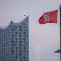 Aerial view of Hamburg flag waving in background of Elbe Philharmonic Hall building