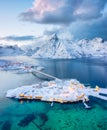 Aerial view on the Hamnoy village, Lofoten Islands, Norway. Landscape in winter time during blue hour. Mountains and water.