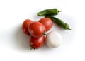 Aerial view of a handful of pear tomatoes, an onion and two green peppers