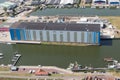 Aerial view harbor Dutch village Makkum with building modern shipyard