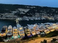 Aerial view of harbor with luxurious yachts at night. Bonifacio, France.