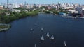 Aerial view of harbor with white beautiful sailing boats in the city pond. Video. Small yachts sailing near the pier on