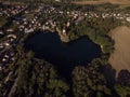 Aerial view of heart shaped lake Kirchbruch See with mountain chapel church Bergkirche Beucha in Brandis Leipzig Saxony