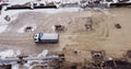Aerial view of heavy machinery, Articulated truck moving dirt on a new road construction site, heavy equipment top down Royalty Free Stock Photo