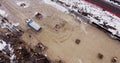 Aerial view of heavy machinery, Articulated truck moving dirt on a new road construction site, heavy equipment top down Royalty Free Stock Photo