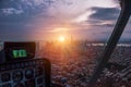 Aerial view from the helicopter cabin on the evening city of New York. The last rays of the setting sun illuminate the city.