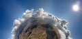 Aerial view from high altitude of little planet with distant city covered with puffy cumulus clouds flying by before Royalty Free Stock Photo