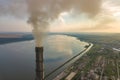 Aerial view of high chimney pipes with grey smoke from coal power plant. Production of electricity with fossil fuel Royalty Free Stock Photo