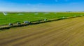 Aerial view on high pressure agricultural water sprinkler, sprayer, sending out jets of water to irrigate corn farm crops Royalty Free Stock Photo