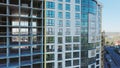 Aerial view of high residential apartment building under construction. Many windows on new apartment building facade