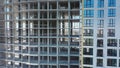 Aerial view of high residential apartment building under construction. Many windows on new apartment building facade