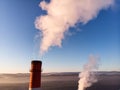 Aerial view of high smoke stack with smoke emission. Plant pipes pollute atmosphere. Industrial factory pollution Royalty Free Stock Photo