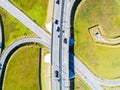 Aerial view of highway in city. Cars crossing interchange overpass. Highway interchange with traffic. Aerial bird`s eye photo of