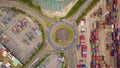 Aerial view of highway junctions with roundabout and containers. Bridge roads shape circle in structure in logistic transportation Royalty Free Stock Photo