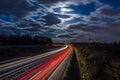 Aerial view of highway at night. Rear red and front white light trail visible on road Royalty Free Stock Photo