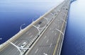 Aerial view of highway in the ocean. Cars crossing bridge interchange overpass. Highway interchange with traffic. Aerial bird`s e Royalty Free Stock Photo