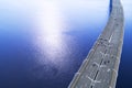 Aerial view of highway in the ocean. Cars crossing bridge interchange overpass. Highway interchange with traffic. Aerial bird`s ey