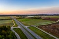 Aerial view of a highway passing through fields at sunrise Royalty Free Stock Photo