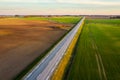 Aerial view of a highway passing through spring agricultural fields