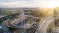 Aerial view highway road network connection or intersection for import export or transportation concept with sunshine light Royalty Free Stock Photo