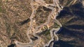 Aerial view of Pakistani trucks on a highway road winding through a mountains, in Punjab, Khyber Pakhtunkhwa, Pakistan.