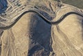 Aerial view of highways built alongside cliffs and desert slopes with good geometric design Royalty Free Stock Photo