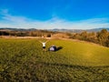 Aerial view of hiker man with arms outstretched celebrating praying in beautiful sunrise with mountains. Royalty Free Stock Photo