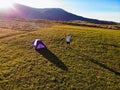 Aerial view of hiker man with arms outstretched celebrating praying in beautiful sunrise with mountains. Royalty Free Stock Photo