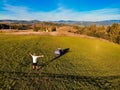 Aerial view of hiker man with arms outstretched celebrating praying in beautiful sunrise with mountains. Royalty Free Stock Photo