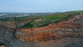 Aerial view hill landscape ocean side. Greenery slopes covered low vegetations