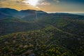 Aerial view of hills with green trees at sunset, Vis, Croatia, road between mountains Royalty Free Stock Photo