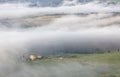 Aerial view of hilltop farmhouses & cypress trees in Tuscany on a foggy spring morning ~ Royalty Free Stock Photo