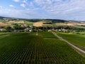 Aerial view on hilly green ineyards and village Urville, champagne vineyards in Cote des Bar, Aube, south of Champange, France