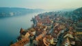 Aerial view of historic town with old buildings in foreground and distant lake vista