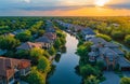 Aerial view of homes along waterway in suburban neighborhood at sunset Royalty Free Stock Photo