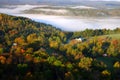 An aerial view of a hot air balloon floating over the Vermont country side