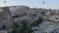 Aerial view from hot air balloon during Sunrise over the fairytale landscape hills of Kapadokya with morning light.