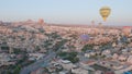 Aerial view from hot air balloon during Sunrise over the fairytale landscape hills of Kapadokya with morning light.