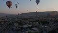 Aerial view from hot air balloon during Sunrise over the fairytale landscape hills of Kapadokya with morning light.