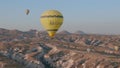 Aerial view from hot air balloon during Sunrise over the fairytale landscape hills of Kapadokya with morning light.