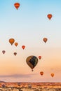 Aerial view of hot balloons flying in sky over Capadoccia during sunset