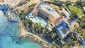 Aerial view of hotel building on sea coastline with blue mediterranean sea water, drone photo of Cyprus resort