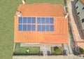 Aerial view of a house with solar panels on the roof