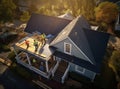 Aerial view of a house under construction with workers on the roof, symbolizing progress and teamwork. Royalty Free Stock Photo